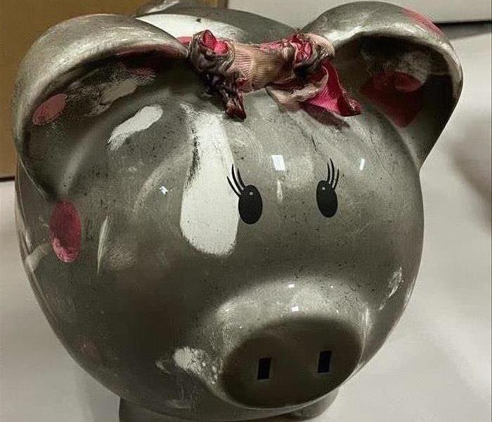 A Piggy Bank covered in soot.