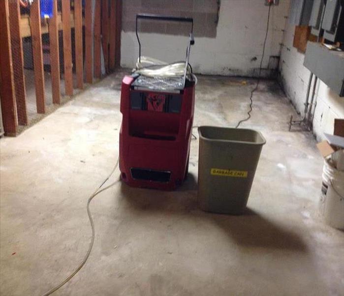 Basement emptied with a dehumidifier in the center